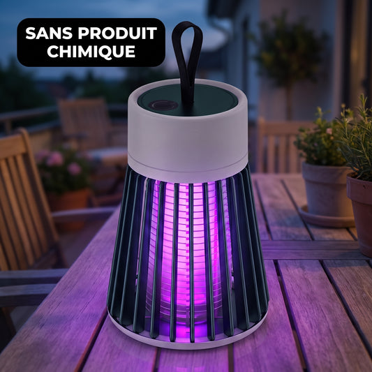 Lampe anti-moustique UV allumée sur une table de jardin à la tombée de la nuit