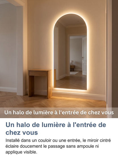 Miroir cintré installé dans une entrée le soir, lumière chaude