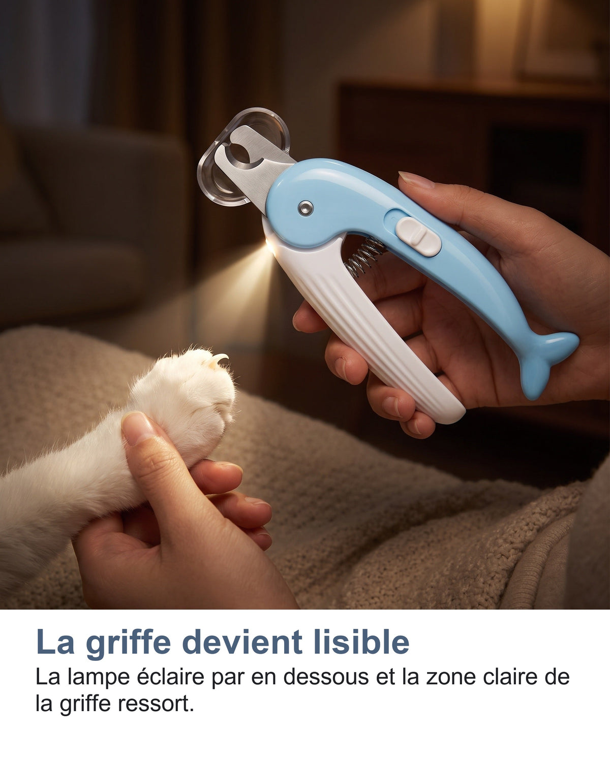 La lampe du coupe-griffes éclaire la griffe d'un animal dans le noir