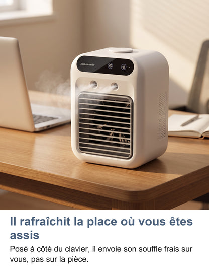 Rafraîchisseur qui brumise sur un bureau à côté d'un ordinateur portable