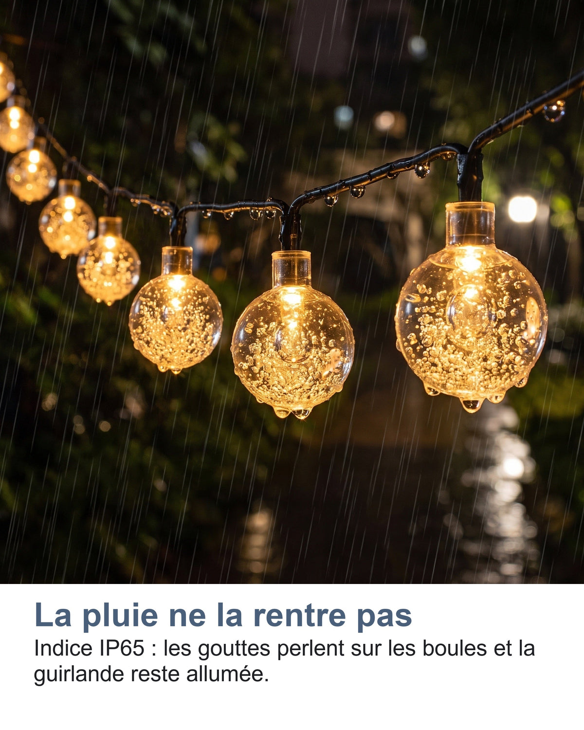 La pluie ne la rentre pas Indice IP65 : les gouttes perlent sur les boules et la guirlande reste allumée.